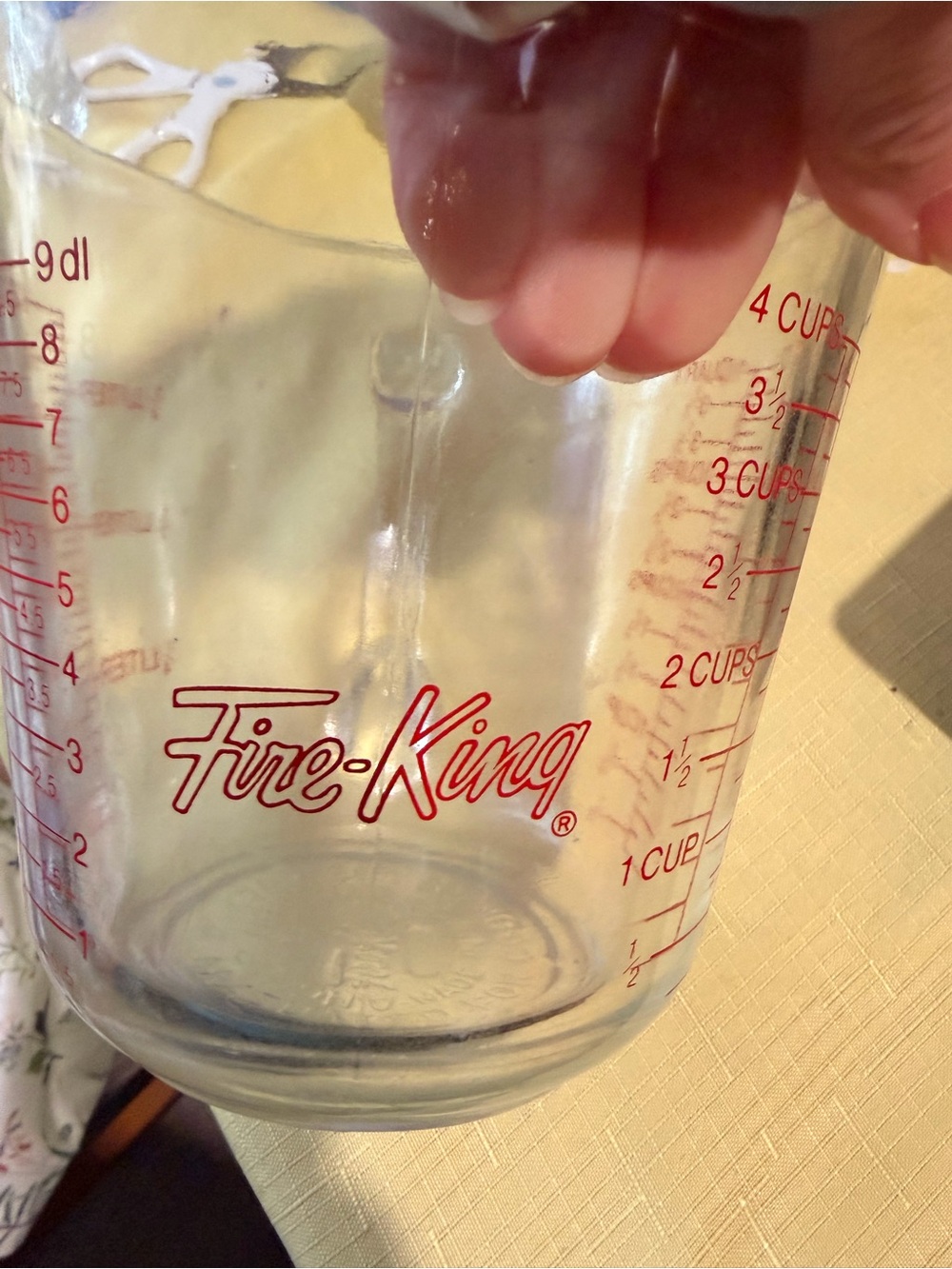 Fire King clear glass measuring cup with red logo and markings